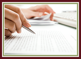 Two hands with a pen and papers working